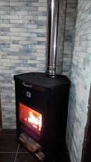Стальной недорогой камин Теплодар ОВ-120 (угловой) фото в интерьере в Слуцке